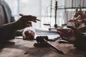 A defendant discusses a plea agreement with their criminal defense attorney in a Pennsylvania courtroom.