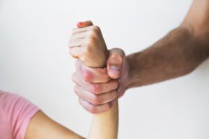 an adult hand tightly gripping a child’s wrist