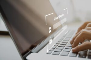 Unrecognizable woman trying to login into laptop or notebook computer with secured login and password interface. Using cybersecurity and confidential login to verify personal information.