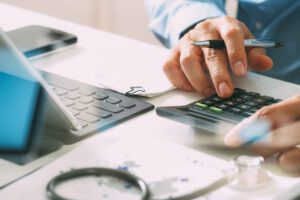 A doctor using a calculator.