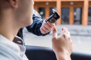 Police officer administering a breathalyzer test to a driver.